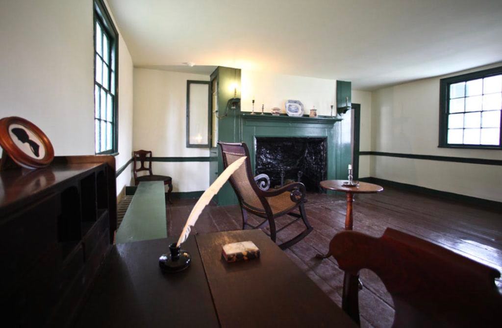 A green fireplace inside the Edgar Allan Poe Cottage