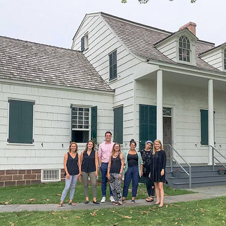 HHT members and team standing in front of a historic house