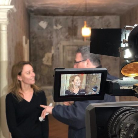 Woman being interviewed in front of a video camera