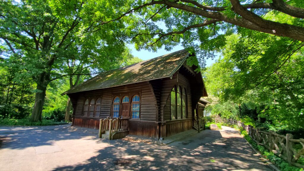 Brown building surrounded by green trees
